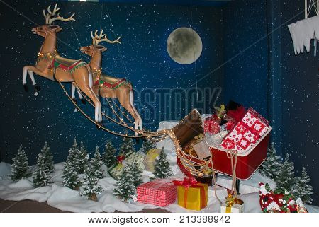 SANT'ELPIDIO A MARE, ITALY - OCTOBER 29, 2017: Reinder of Santa Claus with sled and gift on Christmas shop in Salt'Elpidio a Mare
