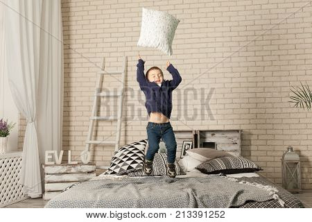 Child Playing With Pillows