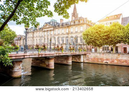 View on the water channel with Rohan palace and bridge in Strasbourg city in France
