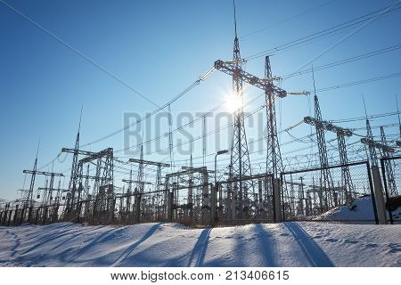 High voltage power lines in the winter. Thermal power plant. High-voltage transformer substation.