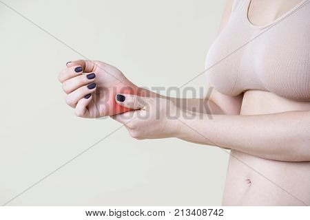 Pain in hand joint inflammation carpal tunnel syndrome on beige background