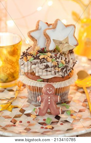 Little christmas cupcake with sugar decorations and cream frosting