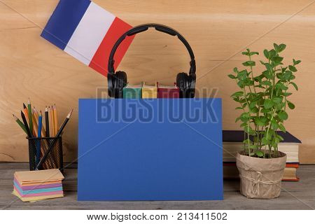 Concept Of Learning French Language - Blank Paper, Flag Of The France, Books, Headphones, Pencils On
