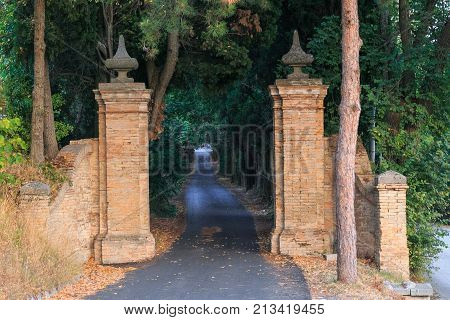 a gate made of red brick. entrance to a private courtyard. Italy