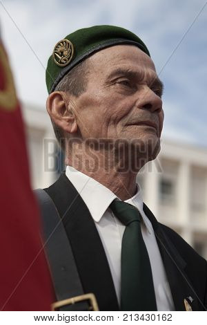 Aubagne, France. May 11, 2012. Portrait of a veteran of the French foreign legion in a green beret with the banner of veterans of the foreign legion during the annual meeting of veterans.