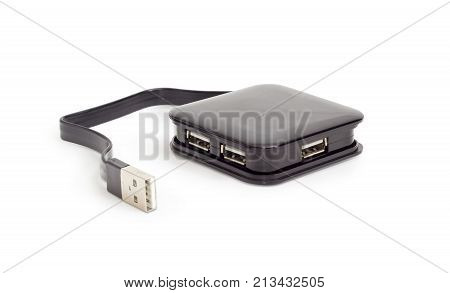 External separate USB hub in black square plastic casing with short cable on a white background