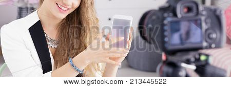 Vlogger Showing Smartphone To Camera