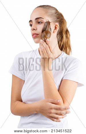 Ahatina on the face of a girl who holds her hands in a white T-shirt on a white isolated background