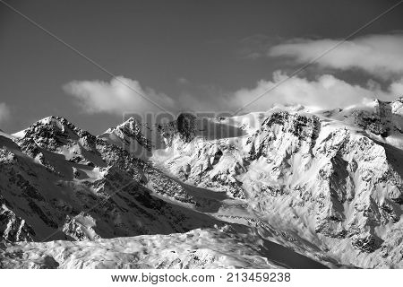 Black and white snow mountains and glacier at sunny evening. Caucasus Mountains in winter. Svaneti region of Georgia.