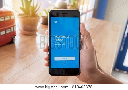 CHIANGMAI THAILAND -Feb 132017:man hand holding Iphone 6s open Twitter app.Twitter is an online social networking and microblogging service that enables users to send and read 