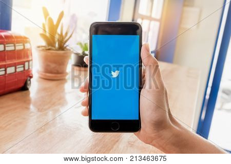CHIANGMAI THAILAND -Feb 132017:man hand holding Iphone 6s open Twitter app.Twitter is an online social networking and microblogging service that enables users to send and read 