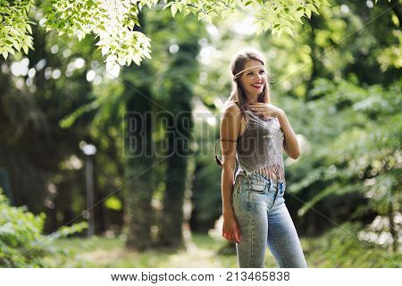 Beautiful happy woman speding time in green nature