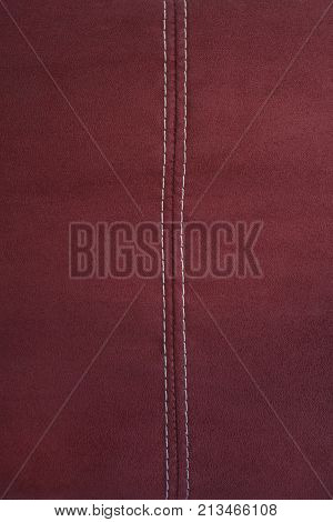 Red alcantara leather with stitching detail background
