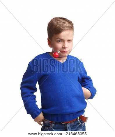 The boy is white in a blue sweater with a stick with a lollipop in his mouth. Winks one eye on a white isolated background