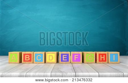 3d rendering of a many colorful toy blocks with letters of the English alphabet in one long line on a wooden desk. Primary school. Kindergarten lessons. English basics.
