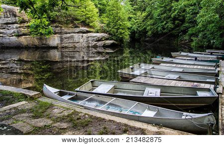Tennessee State Park In Summer. Aluminum Boats And Canoes Line The Shore Of Pickett State Park In Ja