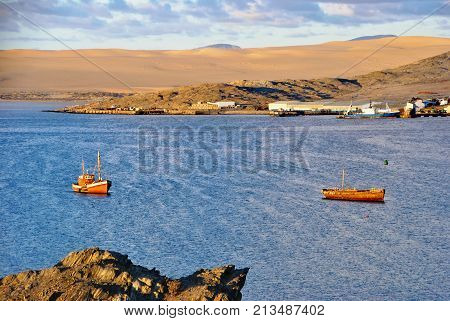 Small fishing boats in bay of Luderitz at sunset. Luderitz is a harbour town lying on one of the least hospitable coasts in Africa