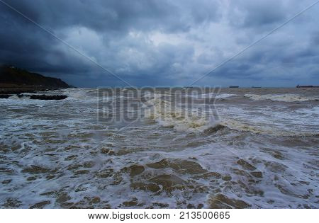 The raging sea with the ships standing in the roadstead.