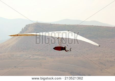 the a man flying on a hang glider