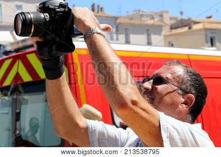Sete, Herault, France  - Aug 21 2017: Man Taking An Overhead Shot In Bright Sunshine Using A Nikon D