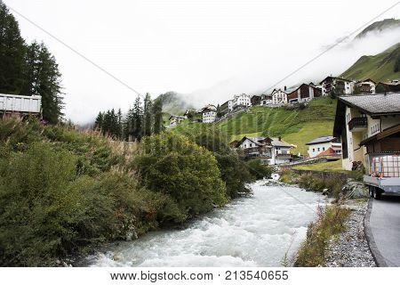 Stream And Glacier From Alps Highest And Most Extensive Mountain Range Flowing Passed At Villages Of