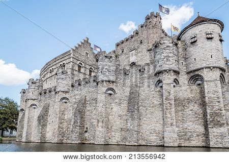 Ghent, Belgium - July 31, 2016: Gravensteen fortress in Ghent from the canal a sunny day of summer