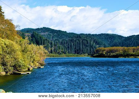 Klamath River which is popular for salmon fishing surrounded by a lush green forest and coastal mountains taken on the Northern California Coast