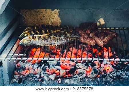 Barbecue In Built Barbecue Grill Fireplace With Fish And Chevaps.