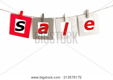 Clip cloths with sale word card hanging on rope isolated on white background