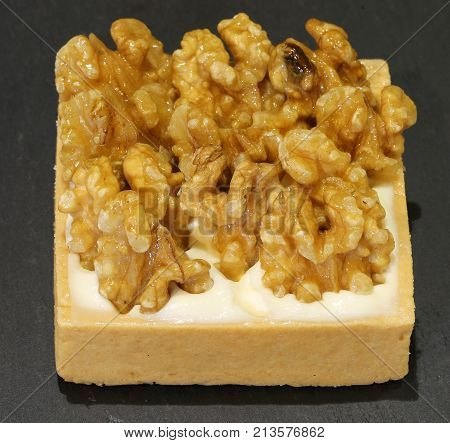 Small Cake With Walnuts In The Konditorei With Background Of Bla