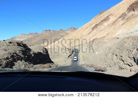Car driving through Death Valley at Sunset.