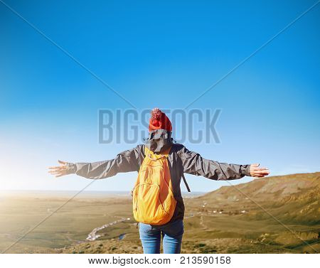 back view of woman traveler on a walk in the Valley of the river of Hveragerdi Iceland. Hiking Tour of Reykjadalur Hot Springs