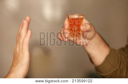 Man saying no more to alcohol with his body language