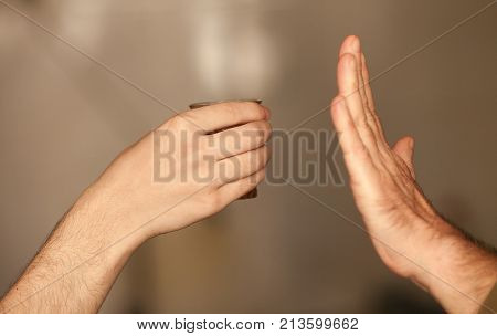 Man saying no more to alcohol with his body language