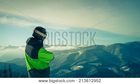 Portrait of a skier in the mountains. Free Lifestyle freedom. Winter in the mountains outdoor. Image toned.