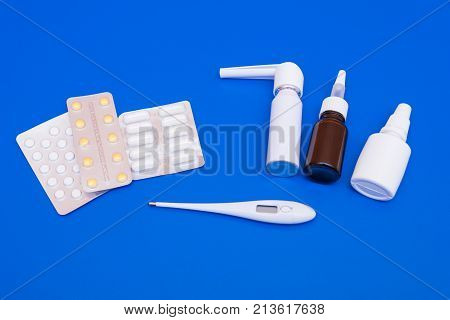 Medications, Pills And A Thermometer On A Bright Background