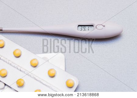 Medications And A Thermometer On A Light Background