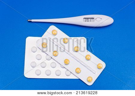 Medications, Pills And A Thermometer On A Bright Background