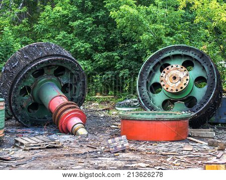 Giant old spare parts of scrap metal. Clogging of the environment. Danger for the future generation.