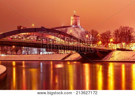 Night Gediminas Tower and King Mindaugas Bridge across Neris River in the city Vilnius, Lithuania, Baltic states.