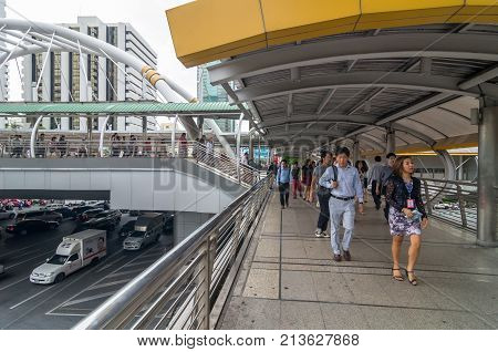 BANGKOK - JUNE 25 2015: Undefined People are walking on the pedestrian bridge which is Bangkok landmark at Chongnonsi SkyBridge at morning for attendance on June 25 2015 in Bangkok Thailand.