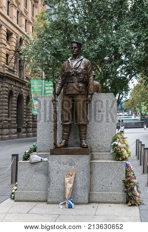 Sydney Australia - March 25 2017: Closeup of the Sailor Soldier statue guarding Cenotaph War Memorial at Martin Place. Backed by green tree street scenery.