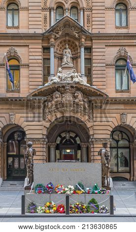 Sydney Australia - March 25 2017: Cenotaph War Memorial at Martin Place. Backed by brown facade and monumental statue of Queen Victoria above entrance to historic building now Shopping mall.