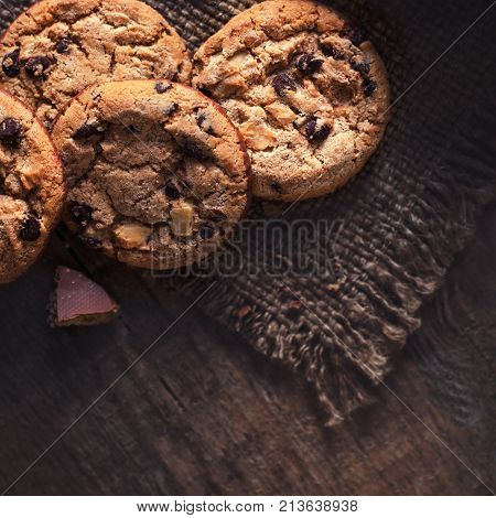 Chocolate chip cookies freshly baked on wooden table. Copy space.
