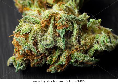 Macro photos of marijuana cones with leaves covered with trichomes. The cannabis plant clse view.