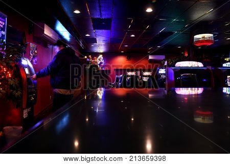 KALISPELL, MONTANA, USA - November 6, 2017: Man taking money out of an ATM machine at a casino.