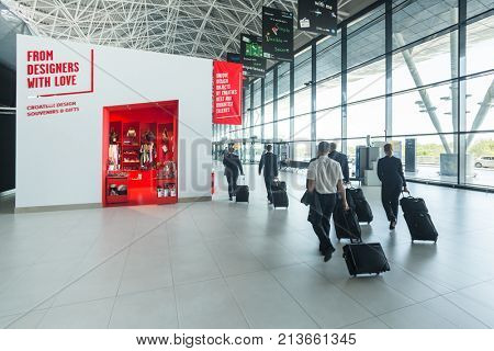 ZAGREB AIRPORT - 24 APRIL 2017: Flight crew passing in front of retail store at departure terminal.