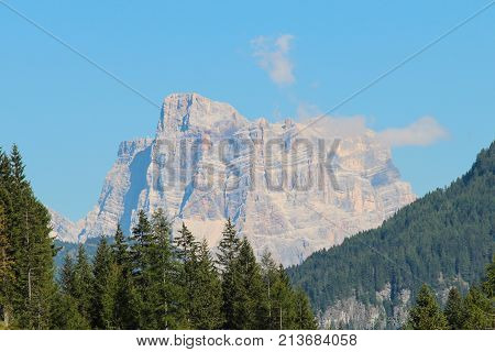 The view of the landscape with a green forest mountains and blue sky. Malga Ciapela Veneto Italy.