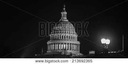 Capitol building glowing in the middle of the night