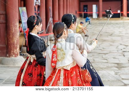 Girls Wearing Korean Traditional Dress And Taking Pictures